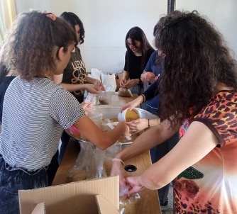 Volunteers prepare food parcels for distribution
